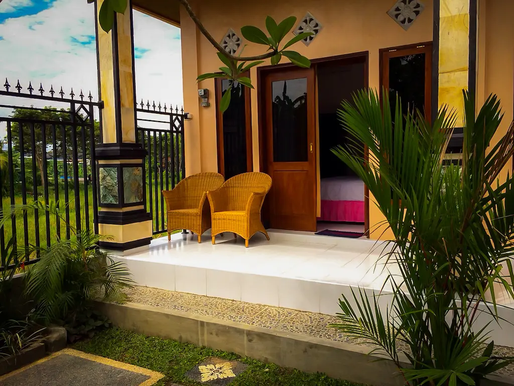 Tropical guesthouse entrance with empty chairs and a welcome mat, representing the failure of skipping audience first business strategy